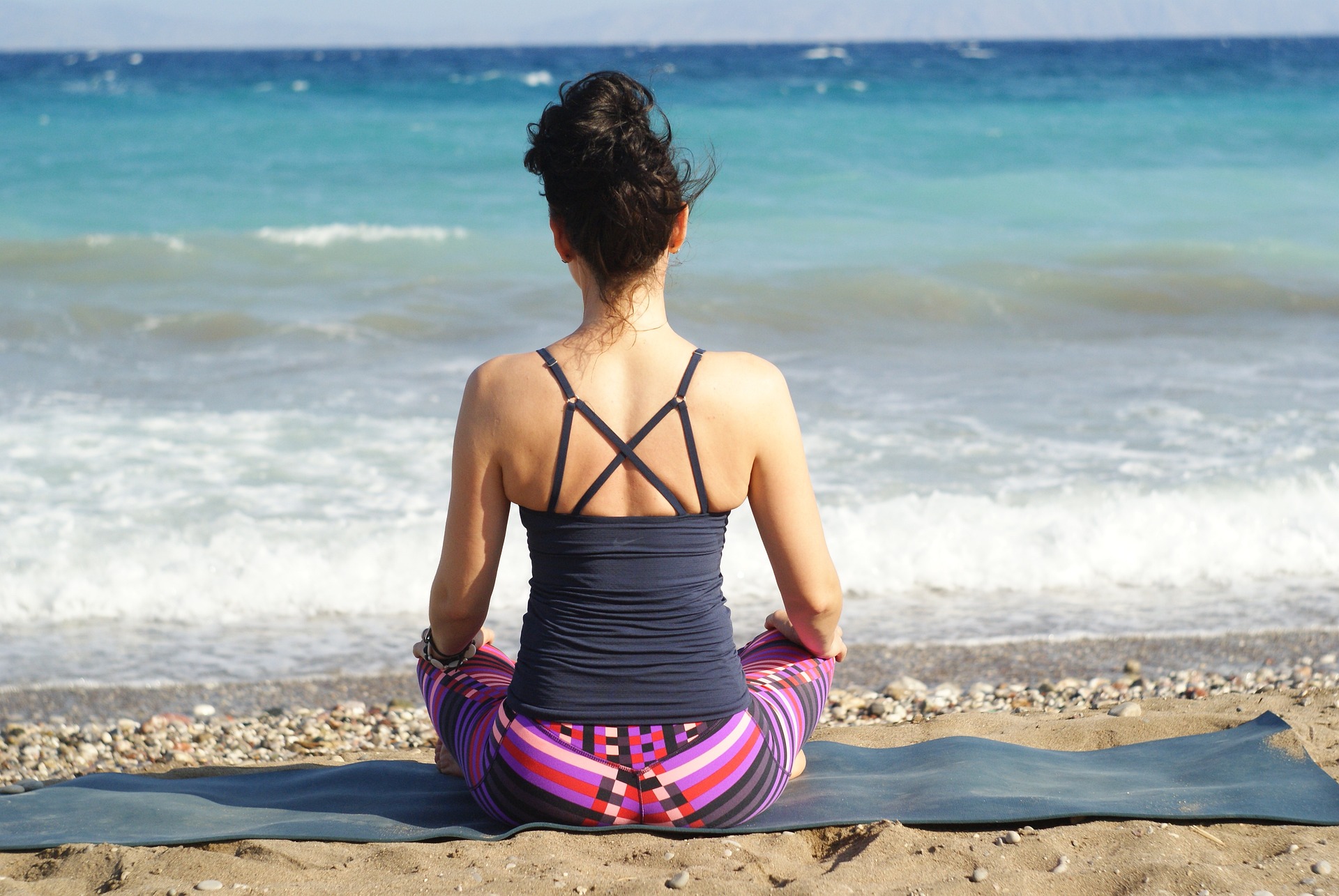 Woman meditating on the beach in Berkeley, California