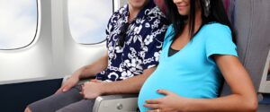 Pregnant Tao to Wellness patient seated on a plane