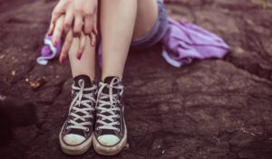 Young teens sitting with sneakers