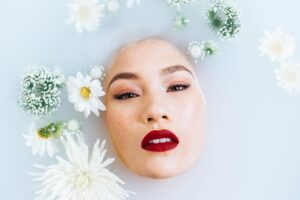 Woman in the bath with her face peeking out of the water.