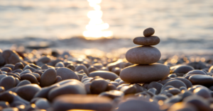 Balanced rocks on the beach near water