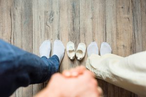 Family picture, spouses holding hands, top view