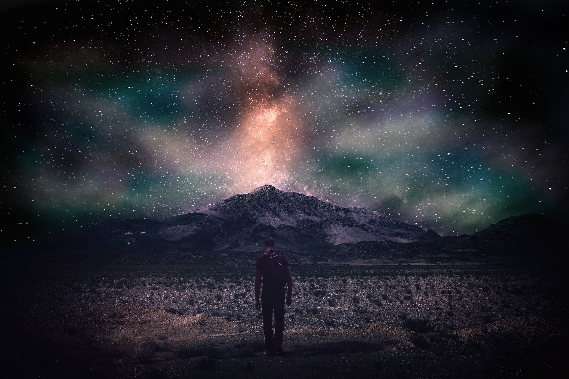 Colorful sky at dusk with man walking