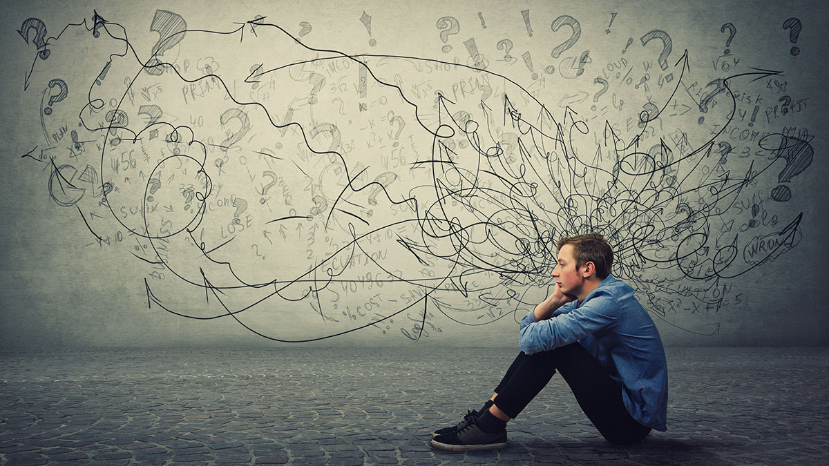 Young man sitting on the ground with abstract chaotic drawings surrounding his head, symbolizing overwhelming thoughts, stress, or ADHD challenges.