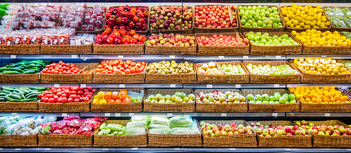 Fresh fruits and vegetables on shelf in supermarket.