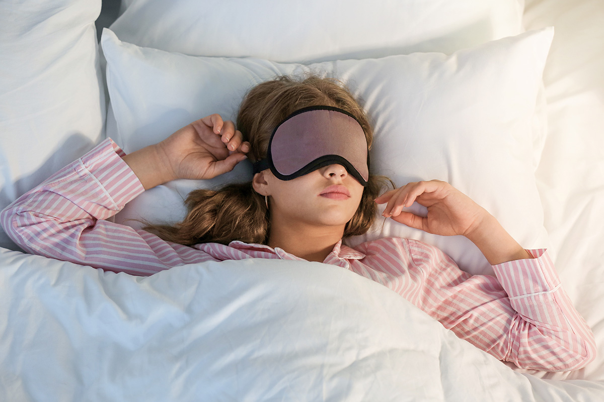 Teenage girl sleeping in bed at night.