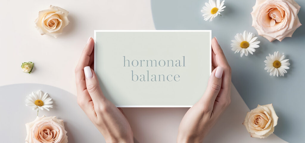 Female hands with the inscription hormonal balance, flowers