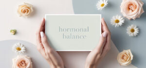 Female hands with the inscription hormonal balance, flowers