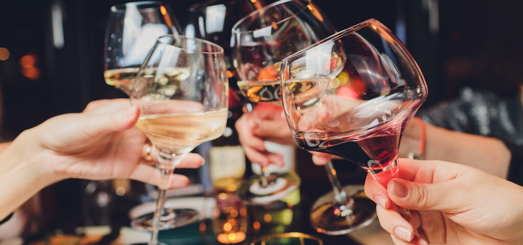 Clinking glasses with alcohol and toasting