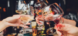 Clinking glasses with alcohol and toasting