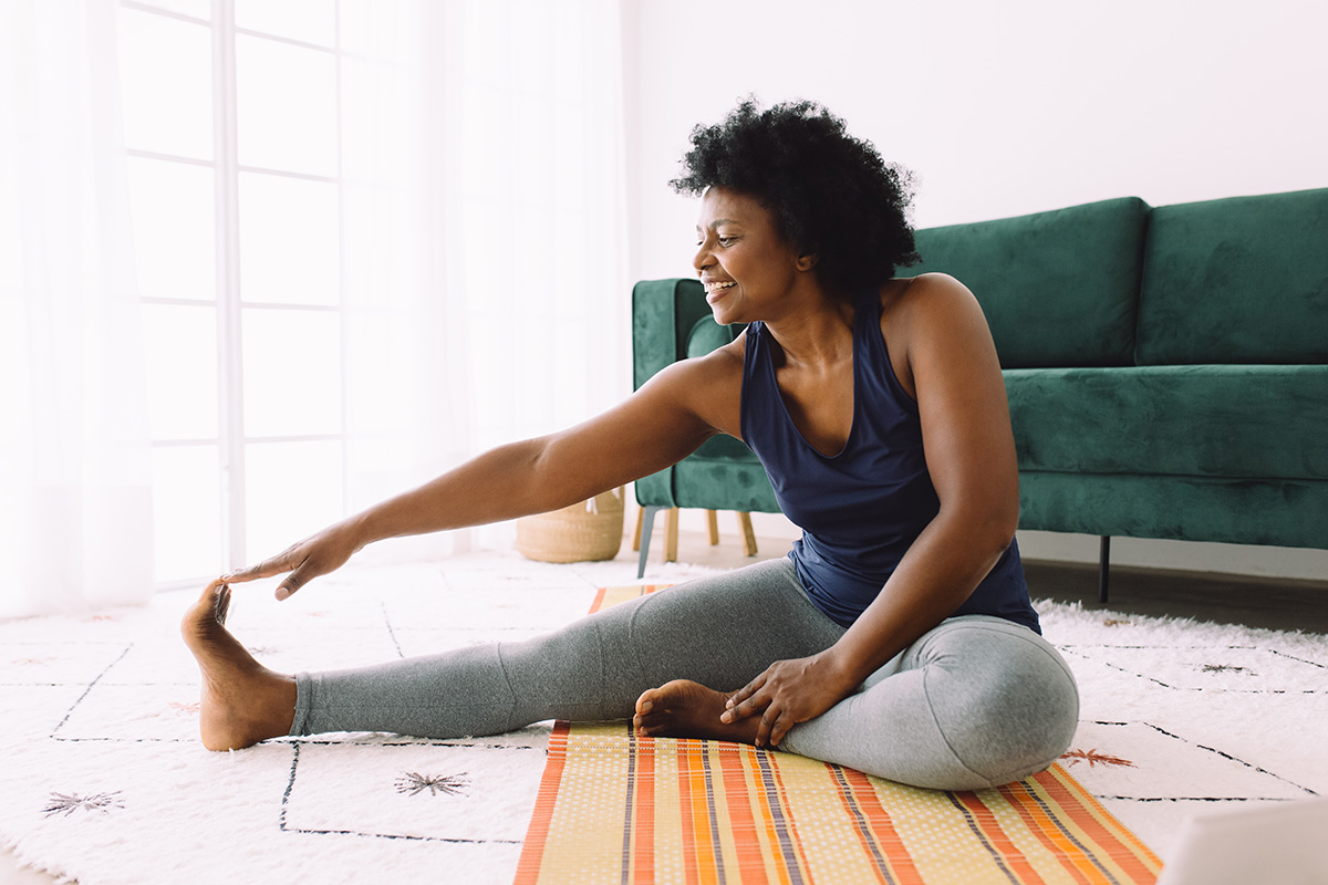Woman doing stretching workout at home
