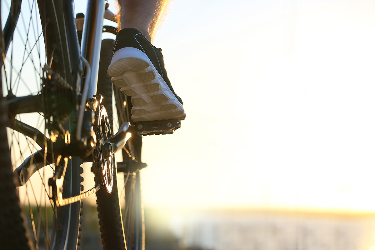 Male cyclist riding bicycle outdoors.