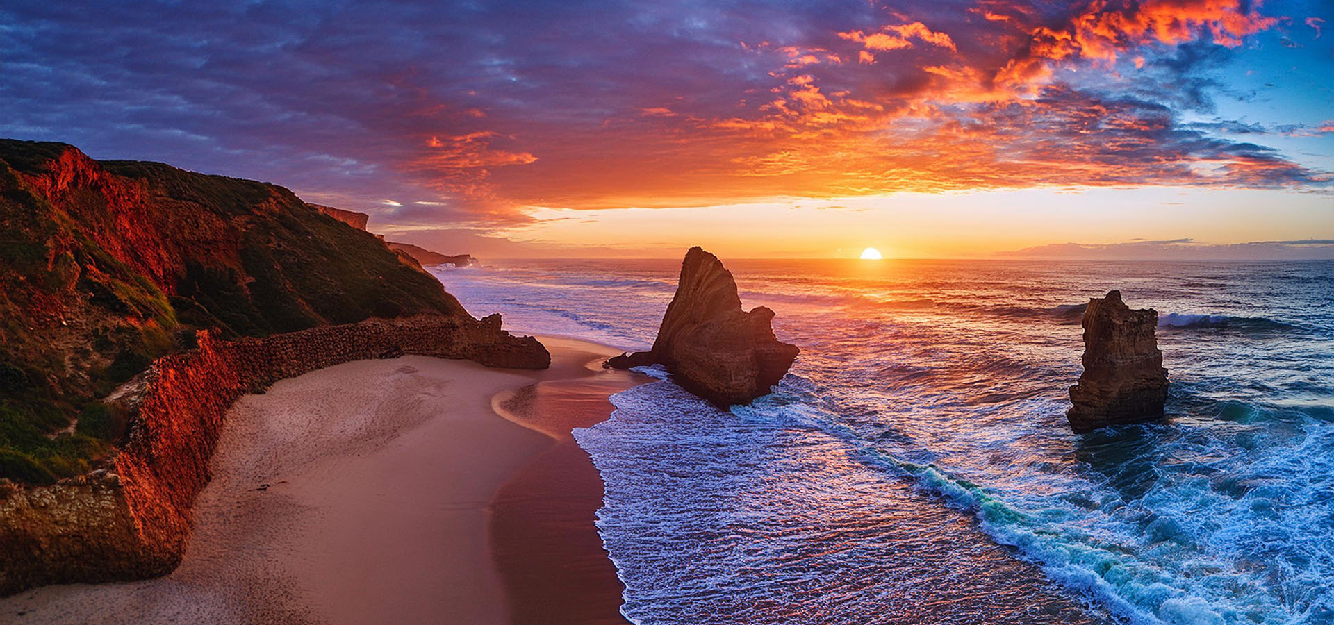 A beach late evening orange and red clouds rock arch formations background