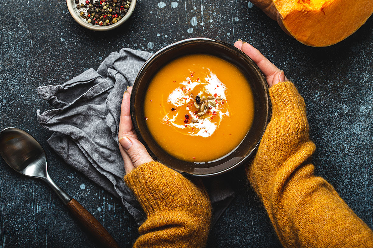 A bowl with pumpkin cream soup