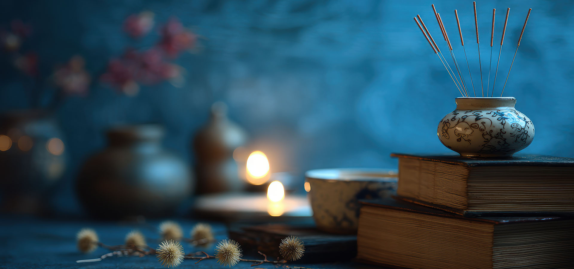 A serene arrangement featuring incense, candles, and books