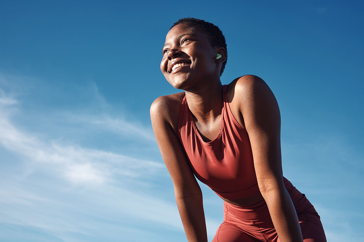 Woman and happy athlete smile after running, exercise and marathon training workout.